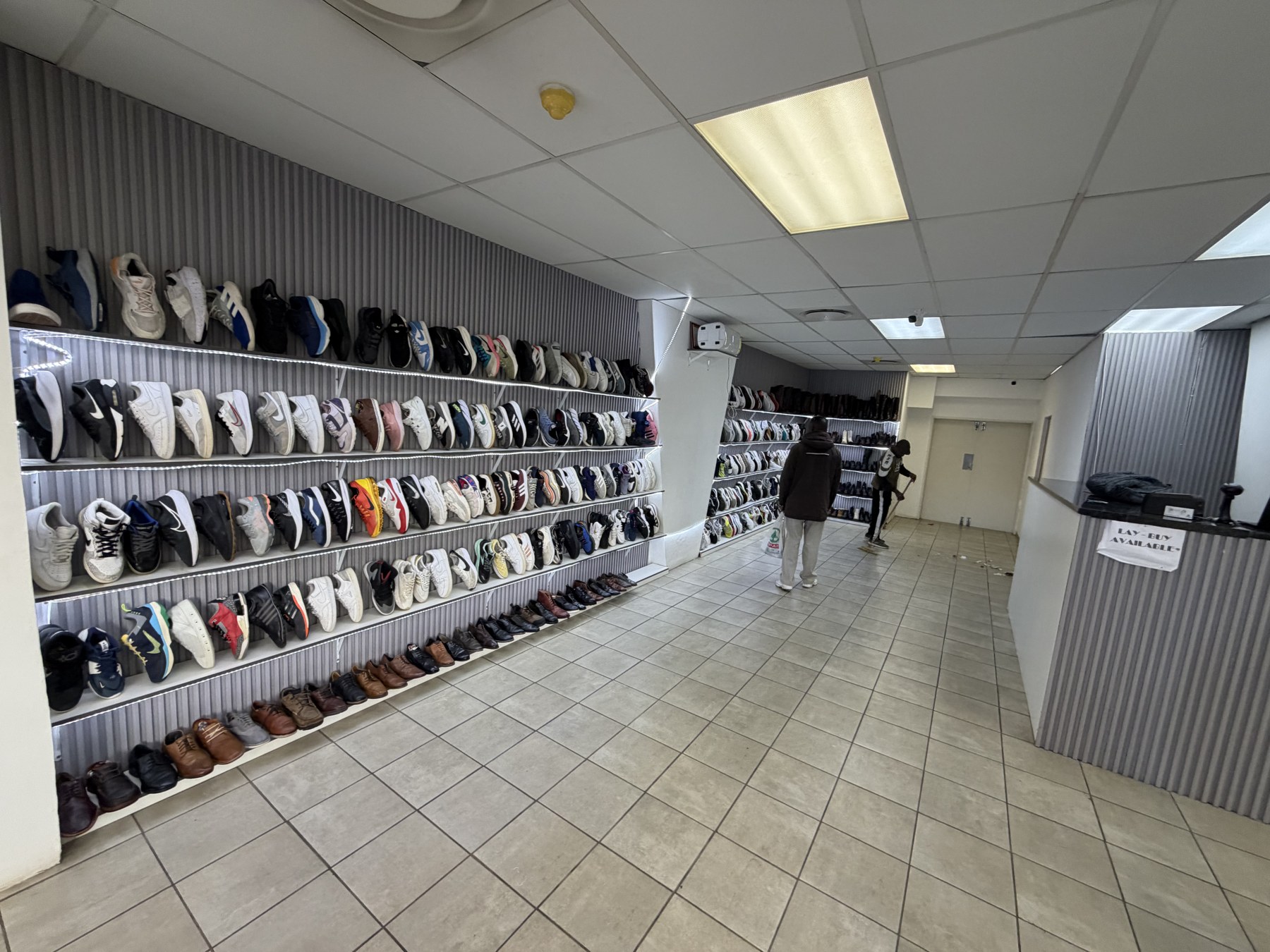 Shelves of second-hand sneakers sorted by size in the Pretoria Central store