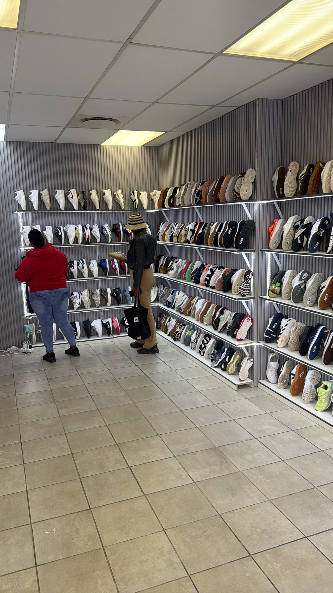 Inside Second Step Couture in Pretoria Central, walls lined with shelves of second-hand sneakers